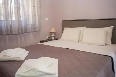 a bedroom with a bed with white towels on it at SundayMar Stone House in Chania Town