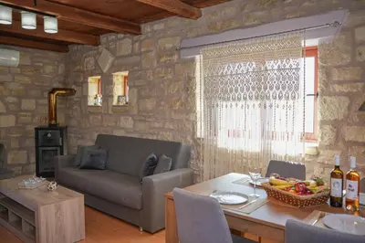a living room with a couch and a table at SundayMar Stone House in Chania Town