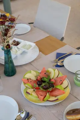 a plate with a fruit salad on a table at Conte Marino Villas in Maleme