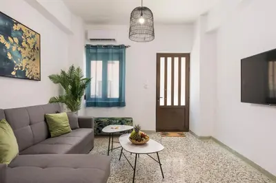 a living room with a couch and a table at Crescendo City House in Chania Town