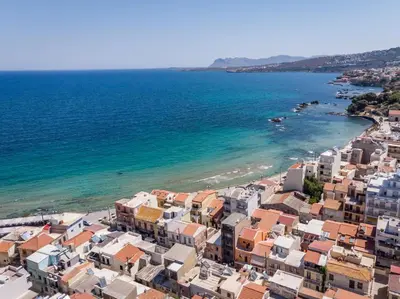 an aerial view of a beach with houses and the ocean at Crescendo City House in Chania Town