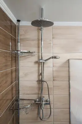 a shower in a bathroom with a wooden wall at Crescendo City House in Chania Town