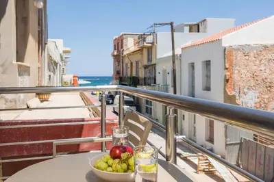 a bowl of fruit sitting on a table on a balcony at Crescendo City House in Chania Town