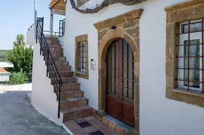a set of stairs leading to a door on a house at Manos Home in Spiliá