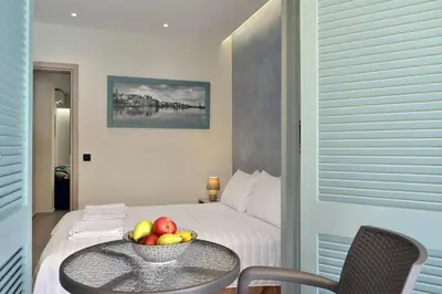 a room with a bed with a bowl of fruit on a table at Amara Porto Living in Chania Town