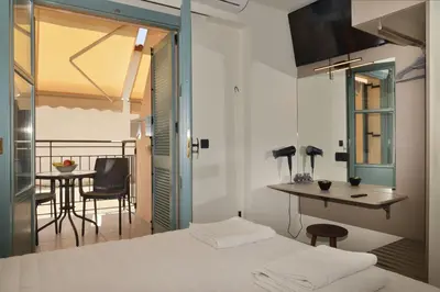 a bedroom with a bed and a desk and a table at Amara Porto Living in Chania Town