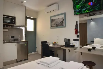 a kitchen with a table and a counter top at Amara Porto Living in Chania Town