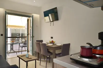 a living room with a table and a dining room at Amara Porto Living in Chania Town