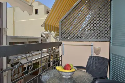 a bowl of fruit sitting on a table on a balcony at Amara Porto Living in Chania Town