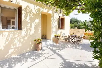 a patio of a house with potted plants and a table at Casa Alta 2-bedroom House in Manoliópoulon