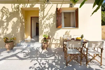 a table and chairs sitting on a patio at Casa Alta 2-bedroom House in Manoliópoulon