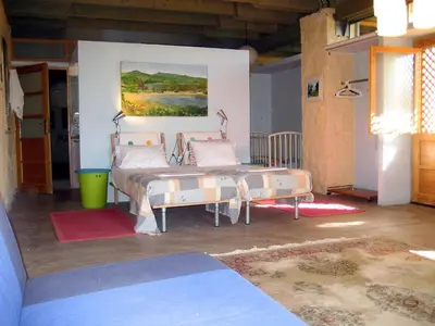 a bedroom with two beds and a painting on the wall at Villa Catani in Kalamaki Chanion