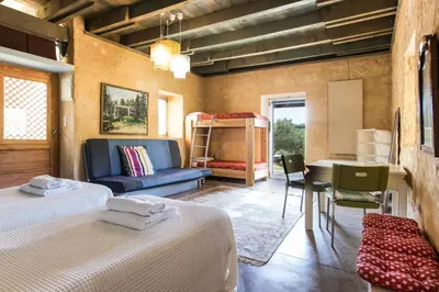 a bedroom with two beds and a couch and a table at Villa Catani in Kalamaki Chanion