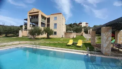 a large swimming pool in front of a house at Villa Catani in Kalamaki Chanion