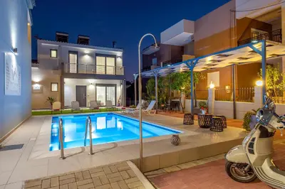 a swimming pool in front of a house with a scooter at Villa Artemis A&B in Chania Town