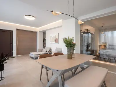 a living room with a table and a bedroom at Mondethea vantage point home in Chania Town