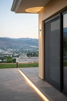 a building with a large glass door with a view at Mondethea vantage point home in Chania Town
