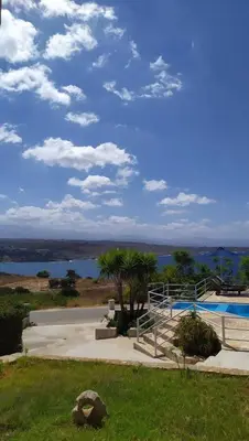 a view of a swimming pool and the water at Nostalgia Villas in Tersanas
