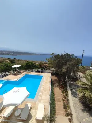 a view of the swimming pool and the ocean at Nostalgia Villas in Tersanas