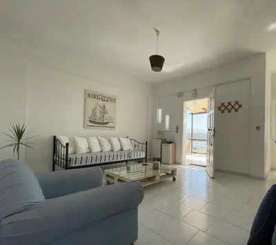 a living room with a couch and a table at Nostalgia Villas in Tersanas