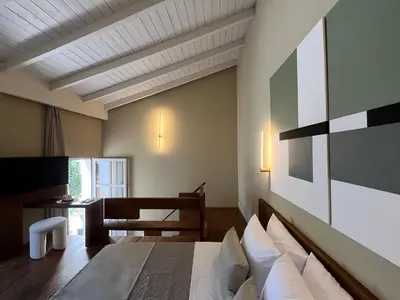 a bedroom with a bed and a table and a chair at Thirty8 Heritage House in Chania Town