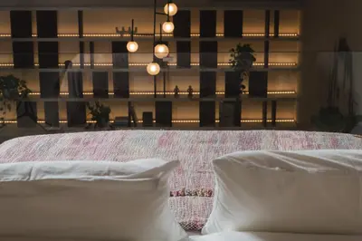 a bedroom with a bed with white sheets and pillows at Urban Lofts in Chania Town
