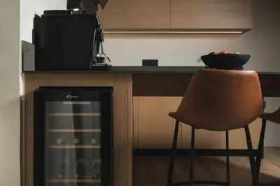 a kitchen with a bar with a chair and a microwave at Urban Lofts in Chania Town