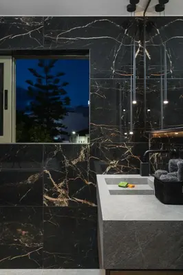 a bathroom with a black marble wall at Urban Lofts in Chania Town