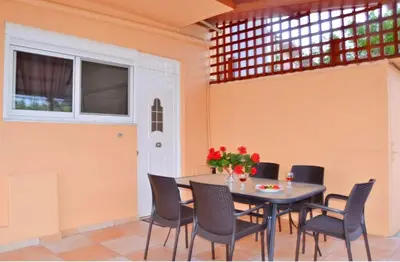 a dining room with a table and chairs at LEMON TREE in Galatás