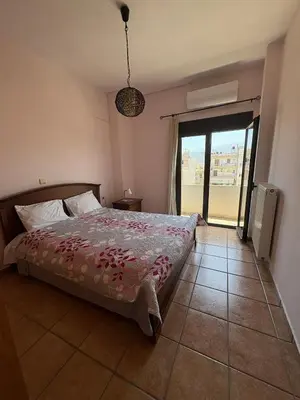 a bedroom with a bed and a large window at CENTRAL HUGE LUXURY APARTMENT and FREE PARKING in Chania Town