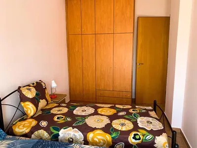 a bedroom with a bed with a flower patterned blanket at CENTRAL HUGE LUXURY APARTMENT and FREE PARKING in Chania Town