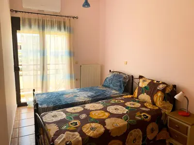 a small bedroom with a bed and a window at CENTRAL HUGE LUXURY APARTMENT and FREE PARKING in Chania Town