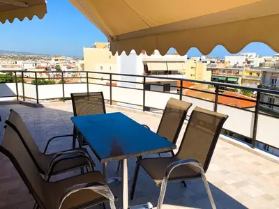 a blue table and chairs on a balcony at CENTRAL HUGE LUXURY APARTMENT and FREE PARKING in Chania Town