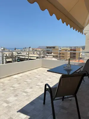 a patio with a table and chairs on a roof at CENTRAL HUGE LUXURY APARTMENT and FREE PARKING in Chania Town