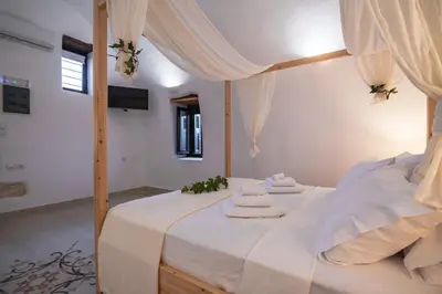 a bedroom with a bed with two towels on it at Marthas DeLight Rooms in Chania Town