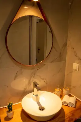 a bathroom with a sink and a mirror at Tabak home Sea side apartment in Chania Town