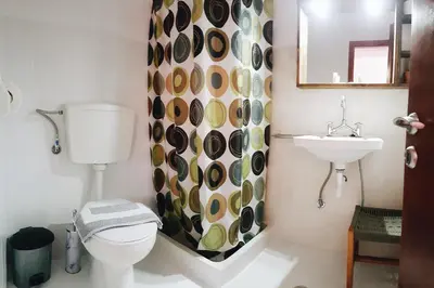 a bathroom with a toilet and a sink at Lefteris Rooms in Kámbos