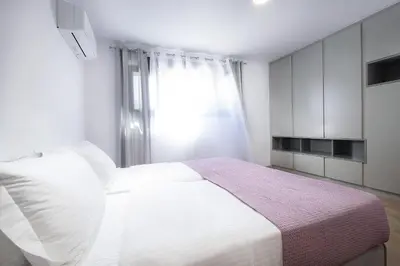 a bedroom with a white bed and a window at Elixsea Villa - Unlimited view of the Blue sea in Kounoupidhianá