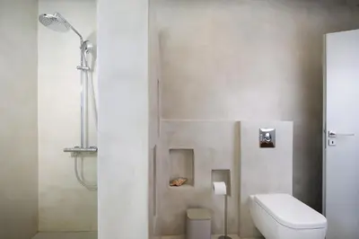 a bathroom with a toilet and a shower at Elixsea Villa - Unlimited view of the Blue sea in Kounoupidhianá