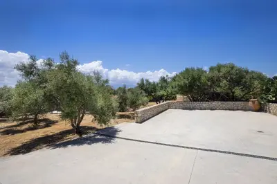 a large patio with trees on top of it at Elixsea Villa - Unlimited view of the Blue sea in Kounoupidhianá
