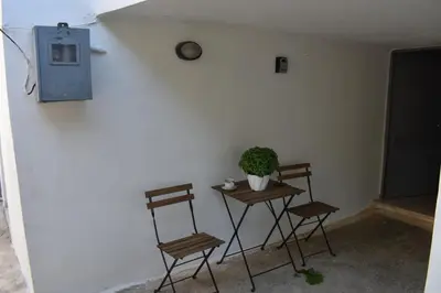 a room with two chairs and a table with a plant at Ioannis Home at Skonizo in Chania Town