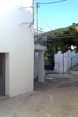 a white building with a staircase and a balcony at Ioannis Home at Skonizo in Chania Town