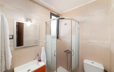 a bathroom with a shower and a toilet and a sink at Villa Gianta in Kissamos