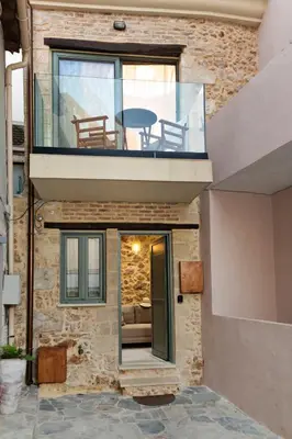 a glass house with a balcony and a table at La 'belle Luxury House Chania in Chania Town