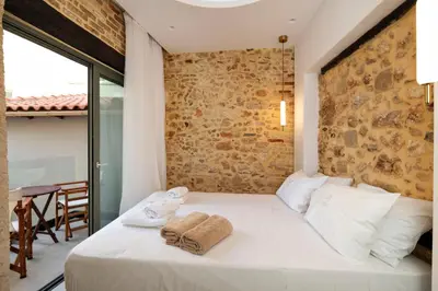 a bedroom with a white bed with towels on it at La 'belle Luxury House Chania in Chania Town