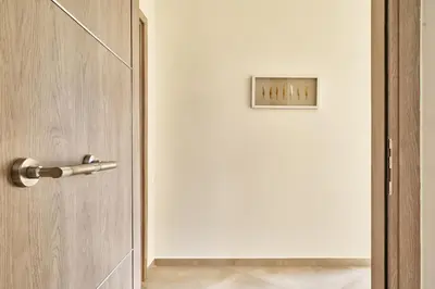 a door leading into a room with a picture on the wall at Adele Apartment in Kissamos