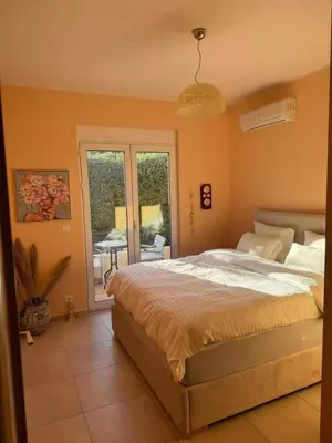 a bedroom with a bed and a view of a patio at Villa Harriet Maria with pool and ocean view Kolimbari, Chania in Kolymvari
