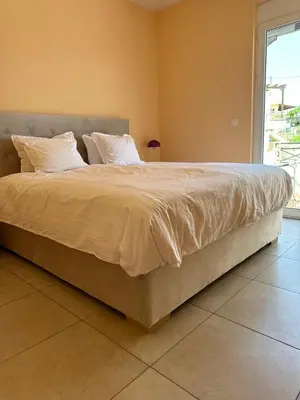 a large bed with white sheets and pillows in a bedroom at Villa Harriet Maria with pool and ocean view Kolimbari, Chania in Kolymvari