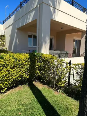 a house with a hedge in front of a building at Villa Harriet Maria with pool and ocean view Kolimbari, Chania in Kolymvari