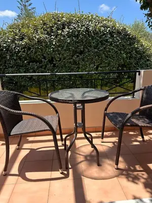 a table and two chairs on a patio at Villa Harriet Maria with pool and ocean view Kolimbari, Chania in Kolymvari
